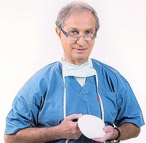 the doctor holds the breast augmentation implant